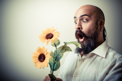 long beard and mustache man giving flowers